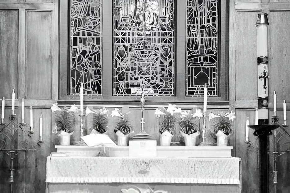 The altar dressed for Easter, lined with candles and lilies